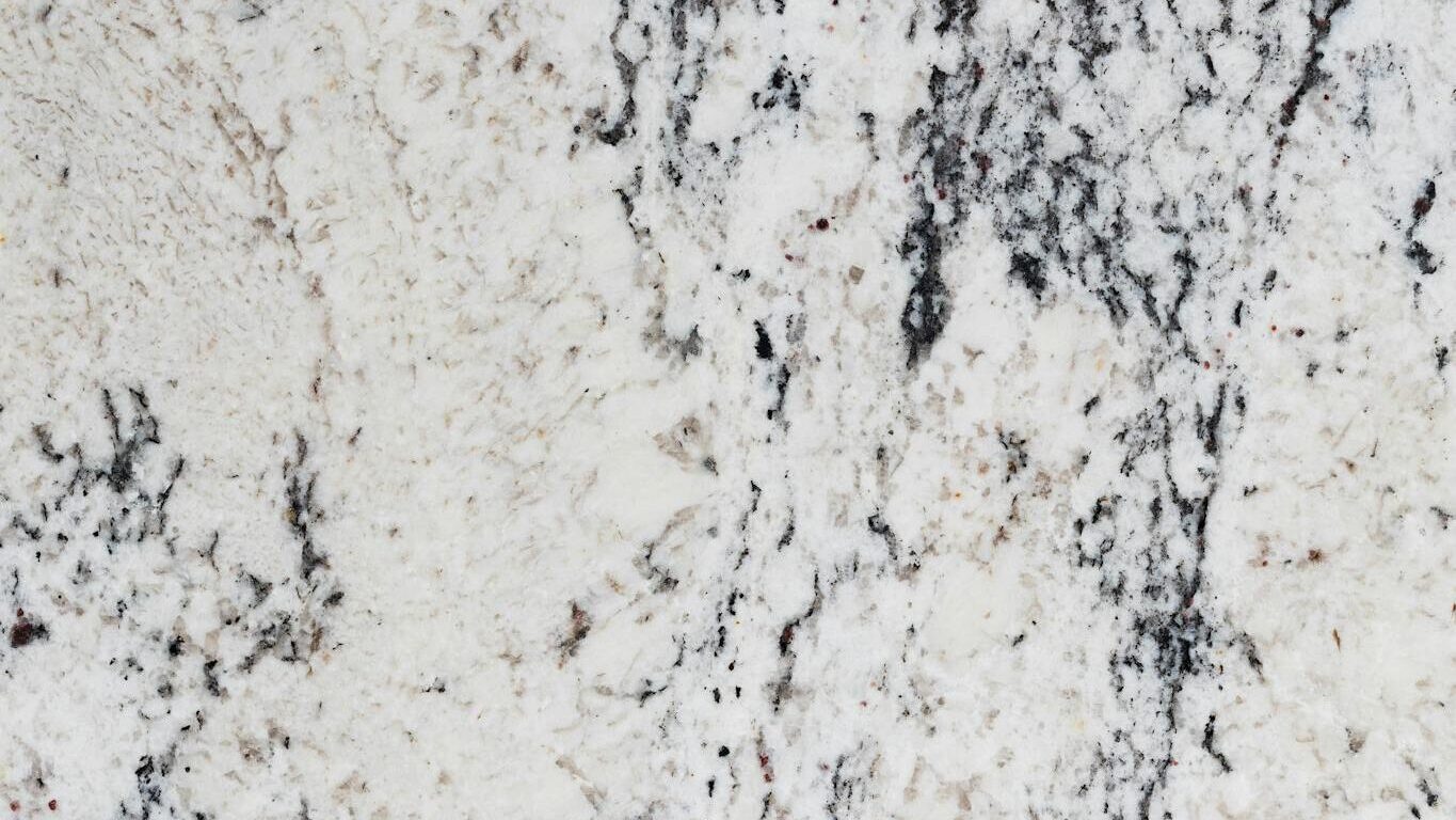 A high-resolution image of white granite with intricate black veining, ideal for backgrounds and designs.